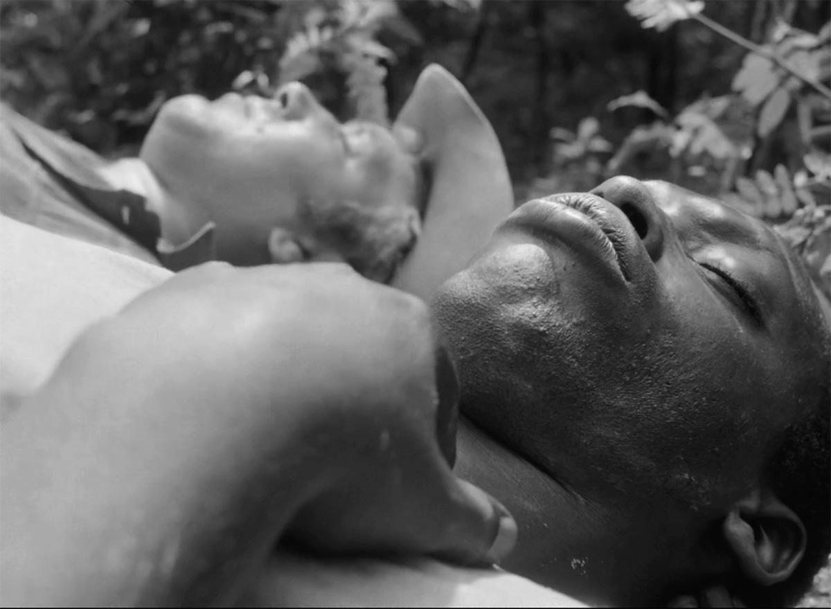 Joe, a Black man, and Glen, a white man, lie on the ground in the woods. From Ibrahim Shaddad’s ‘Hunting Party.’ Courtesy of Flaherty Seminar.