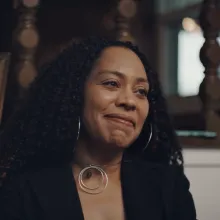 Jacqueline Blocker, person with long dark hair and silver hoop earrings